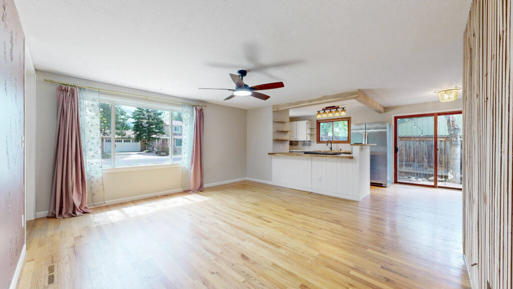 Open connection between main living space and kitchen, bright and sunny