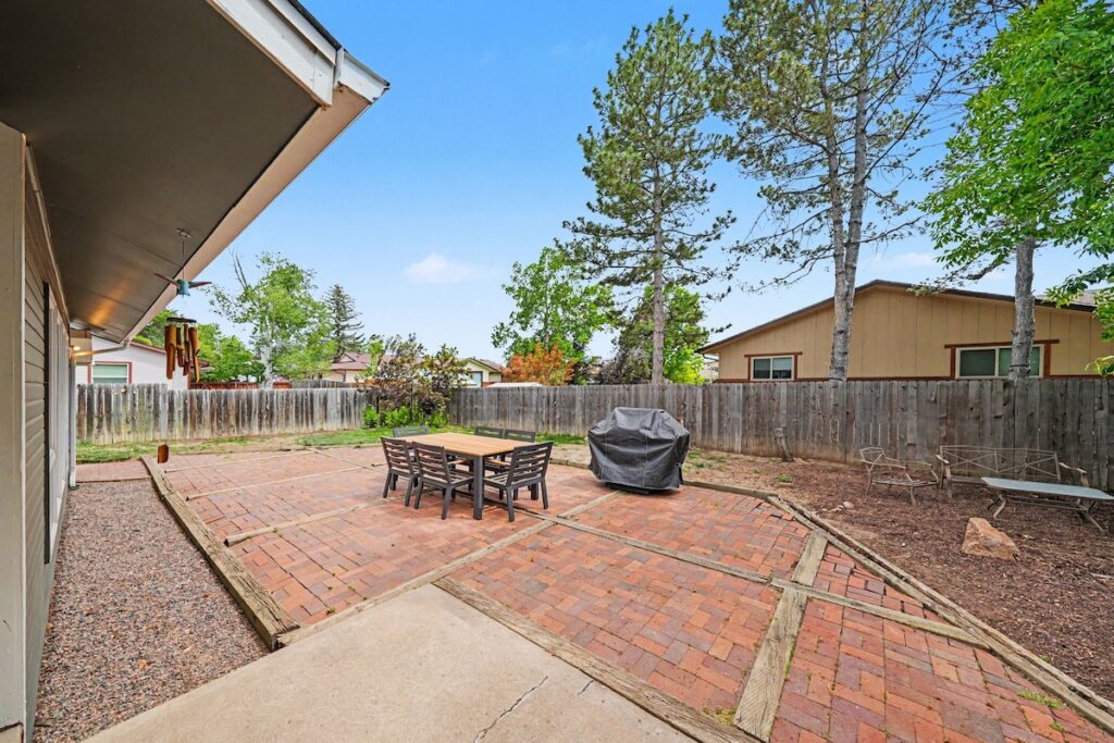 Private fenced backyard with mature trees and patio at 2126 Genoa Court