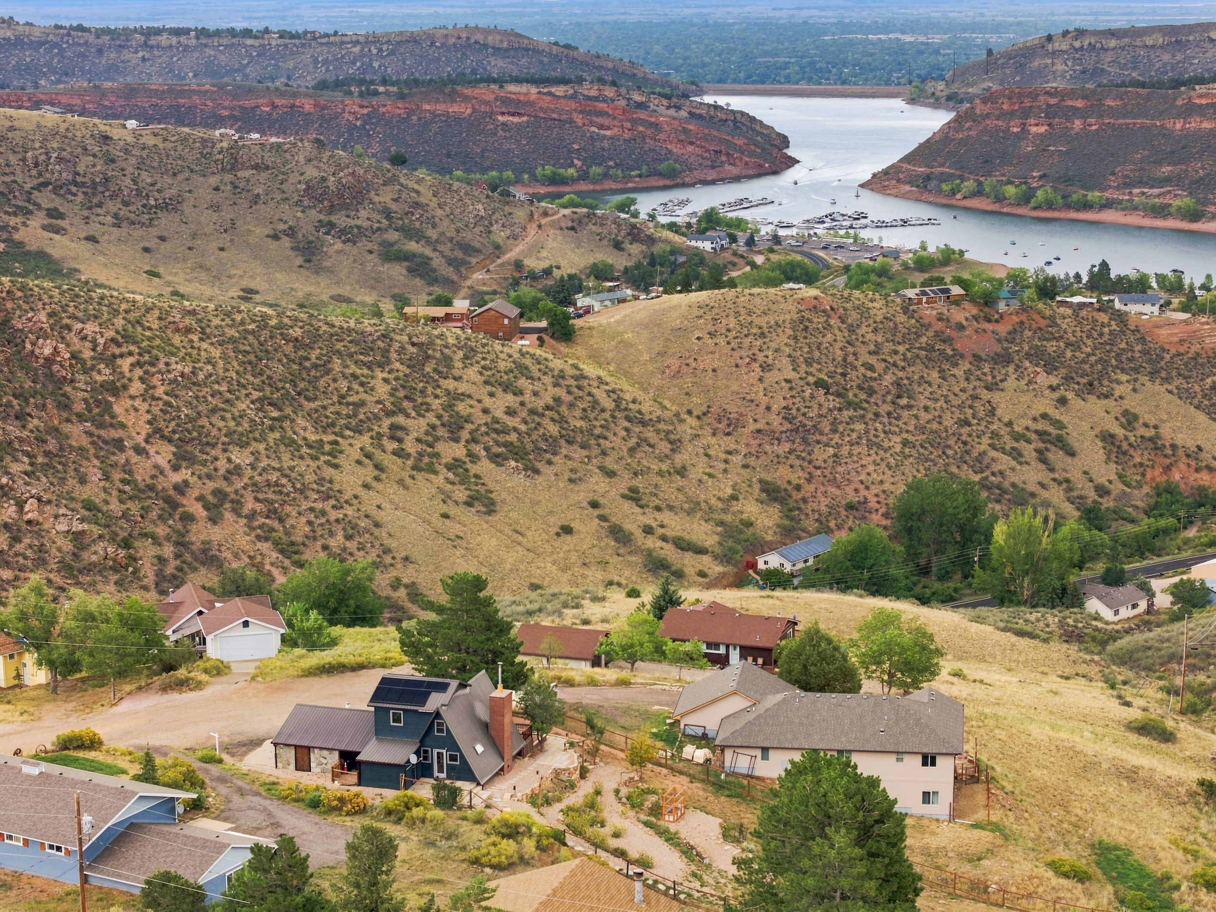 Aerial view of 4616 Cliff View Lane Fort Collins with Horsetooth Reservoir and Inlet Bay Marina visible in the background