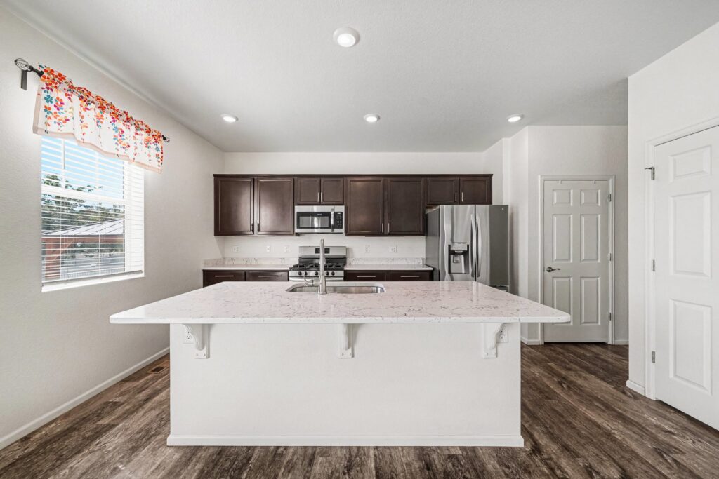 Kitchen with large island and quartz countertops at 5370 Silverleaf Ave in Firestone